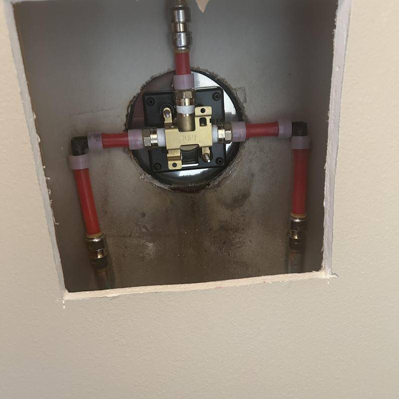 Installing shower valve in Hot Springs Village, AR by Bowen Plumbing